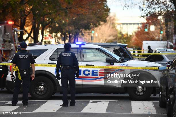 Police investigate a shooting incident in which a DC Police officer was involved in Washington, D.C., November 22 at 12th and M streets in NW.