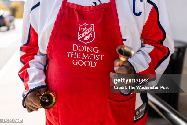 Stuart Goins a bell ringer for the Salvation Army, rings bells outside of Giant Supermarket in Alexandria, Virginia on November 22, 2023. As cash...