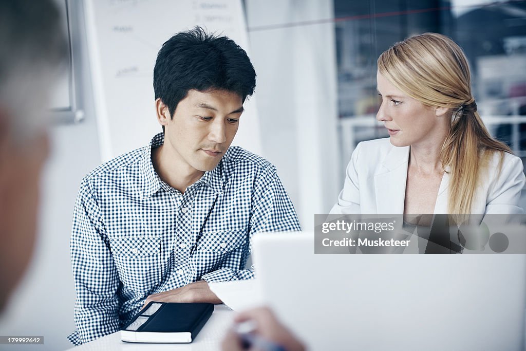 Colleagues having a meeting in a boardroom