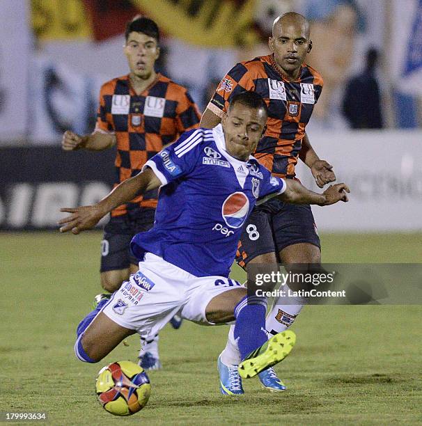 Johnny Ramirez of Millonarios struggles for the ball with Edwin Movil of Boyaca Chico during a match between Millonarios and Boyaca Chico as part of...