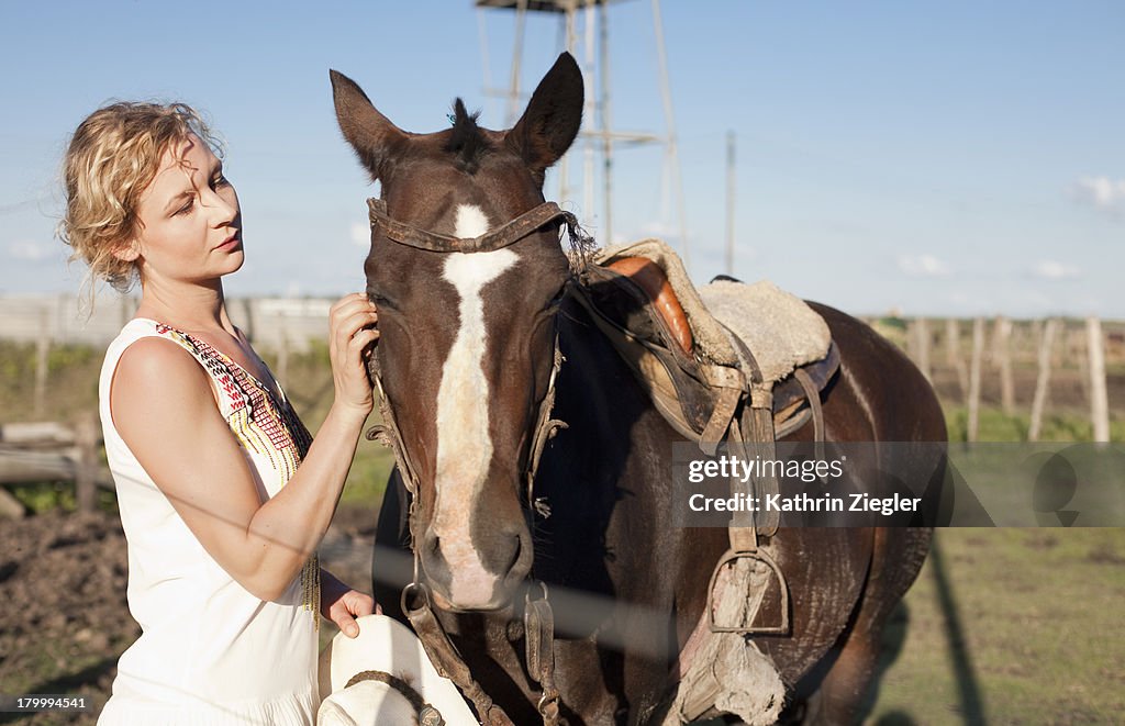 Woman petting her horse