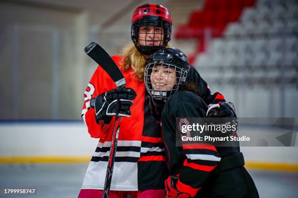 ice hockey players pose with hugs - ice hockey uniform stock pictures, royalty-free photos & images