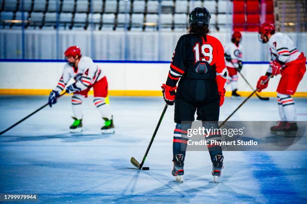 ice hokey training, rear view - ice hockey uniform stock pictures, royalty-free photos & images