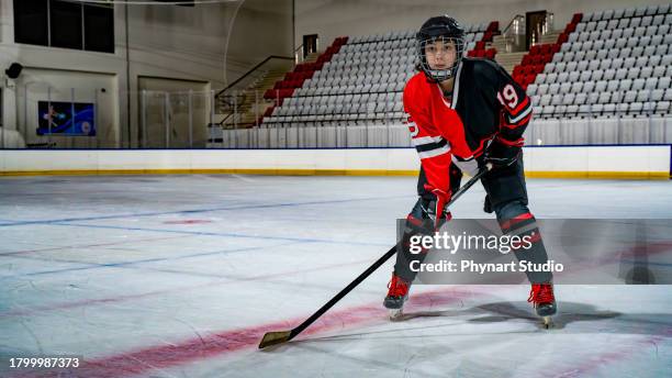 women's ice hockey offense player portrait - ice hockey uniform stock pictures, royalty-free photos & images