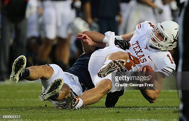 Alani Fua of BYU Cougars sacks quarterback David Ash of the Texas Longhorns during the first half of an NCAA football game September 7, 2013 at...