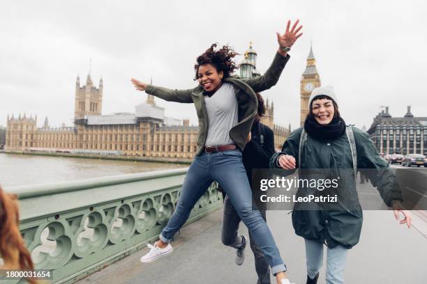 group of multi ethnic friends enjoying london - jump for joy stock pictures, royalty-free photos & images