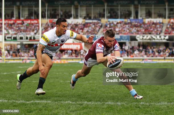 Clinton Gutherson of the Sea Eagles scores a try during the round 26 NRL match between the Manly Warringah Sea Eagles and the Penrith Panthers at...