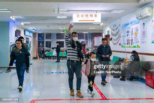 Parents with children who are suffering from respiratory diseases are lining up at a children's hospital in Chongqing, China, on November 23, 2023.