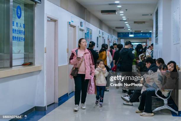 Parents with children who are suffering from respiratory diseases are lining up at a children's hospital in Chongqing, China, on November 23, 2023.