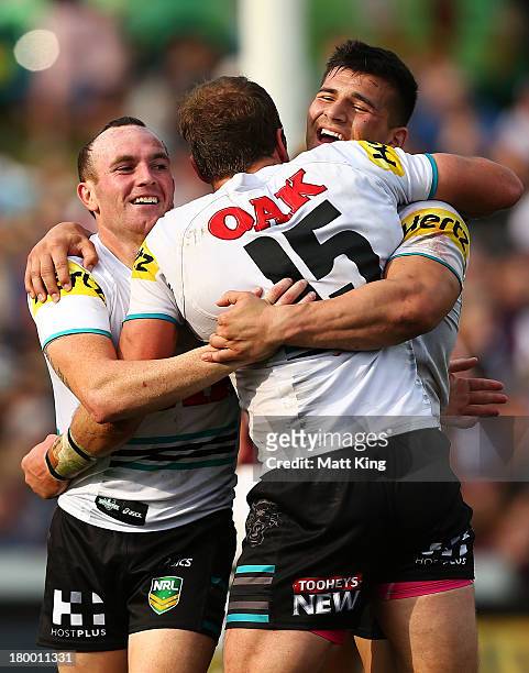 Luke Walsh, Clint Newton and Josh Mansour of the Panthers celebrate after the try to Dean Whare during the round 26 NRL match between the Manly...