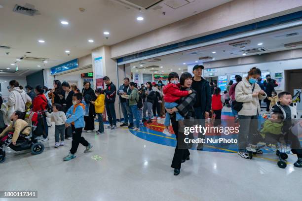 Parents with children who are suffering from respiratory diseases are lining up at a children's hospital in Chongqing, China, on November 23, 2023.