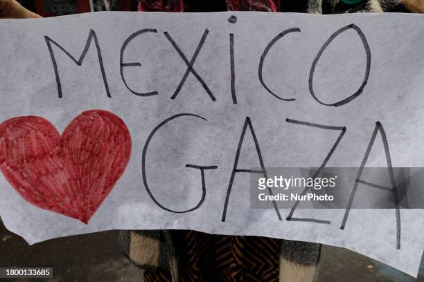 Palestinian woman is holding a sign while demonstrating outside the Egyptian embassy in Mexico City, demanding the immediate entry of a humanitarian...