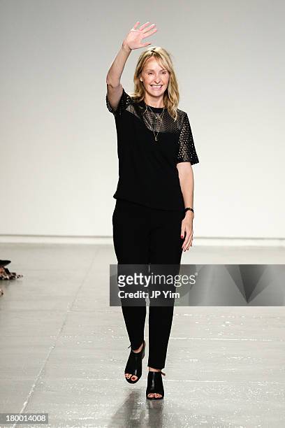 Designer Rebecca Taylor waves to the audience at the conclusion of her Rebecca Taylor runway show during Spring 2014 Mercedes-Benz Fashion Week at...