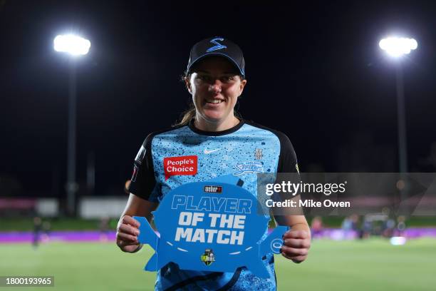Tahlia McGrath of the Strikers pose for a photo while holding the Player of the Match award following the team's victory in the WBBL match between...
