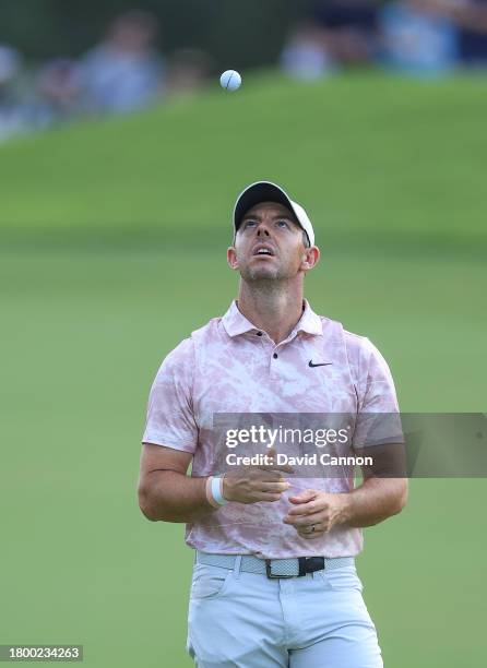 Rory McIlroy of Northern Ireland tosses his golf ball whilst waiting to play his second shot on the 18th hole during the third round on Day Three of...