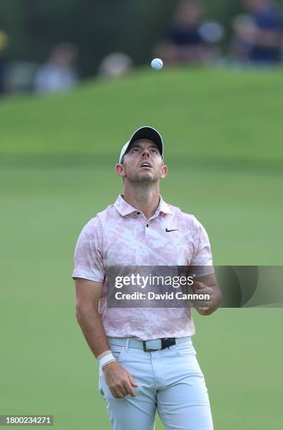 Rory McIlroy of Northern Ireland tosses his golf ball whilst waiting to play his second shot on the 18th hole during the third round on Day Three of...