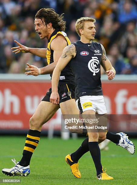 Ivan Maric of the Tigers celebrates a goal next to Dennis Armfield of the Blues during the First Elimination Final AFL match between the Richmond...