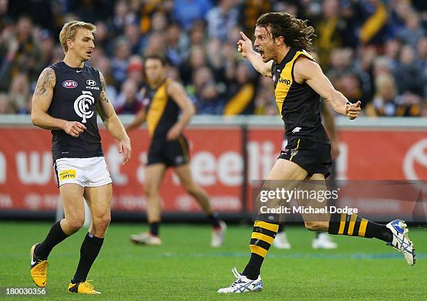 Ivan Maric of the Tigers celebrates a goal next to Dennis Armfield of the Blues during the First Elimination Final AFL match between the Richmond...