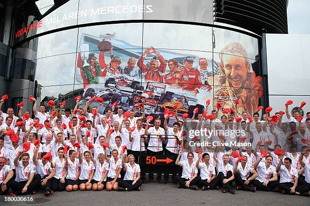 Jenson Button, Martin Whitmarsh and Sergio Perez and McLaren team mates pose for a team photograph as they celebrate their 50th year in Formula One...