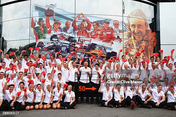 Jenson Button, Martin Whitmarsh and Sergio Perez and McLaren team mates pose for a team photograph as they celebrate their 50th year in Formula One...
