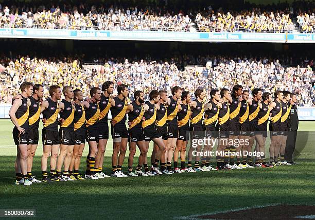 The Tigers players stand for the national anthem during the First Elimination Final AFL match between the Richmond Tigers and the Carlton Blues at...
