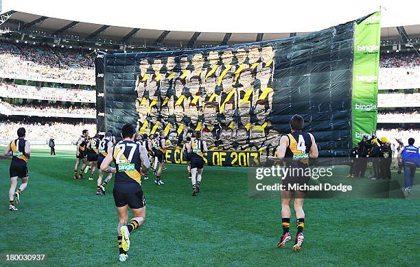 The Tigers players run to the banner during the First Elimination Final AFL match between the Richmond Tigers and the Carlton Blues at Melbourne...