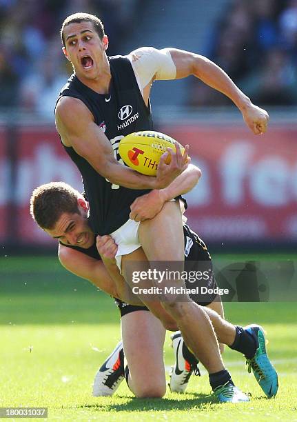 Daniel Jackson of the Tigers tackles Ed Curnow of the Blues during the First Elimination Final AFL match between the Richmond Tigers and the Carlton...