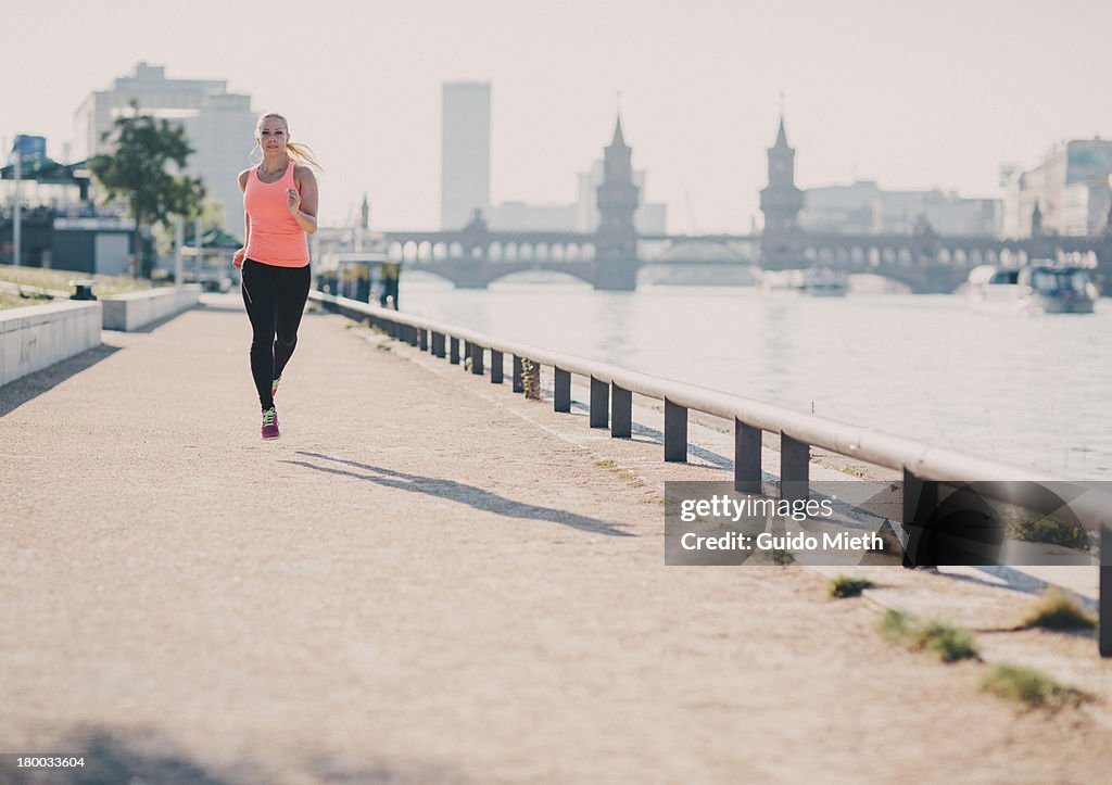 Woman running in urban scene.
