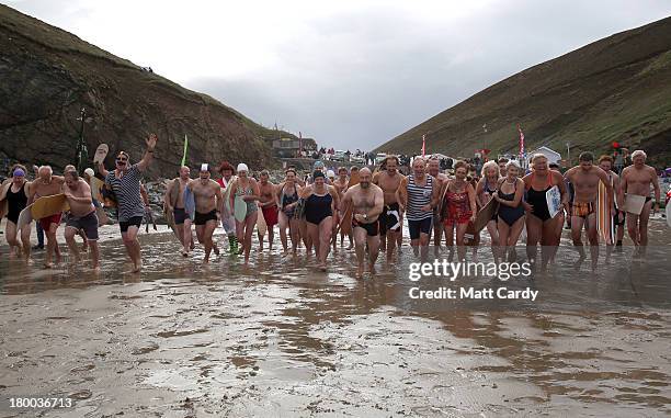 Belly boarders run into the sea to take part in the first heat of the annual World Belly Boarding Championships at Chapel Porth on September 8 2013...