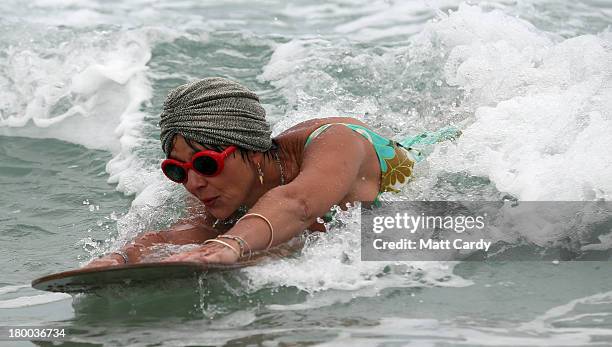 Belly boarder catches a wave as she takes part in the senior ladies heats of the annual World Belly Boarding Championships at Chapel Porth on...