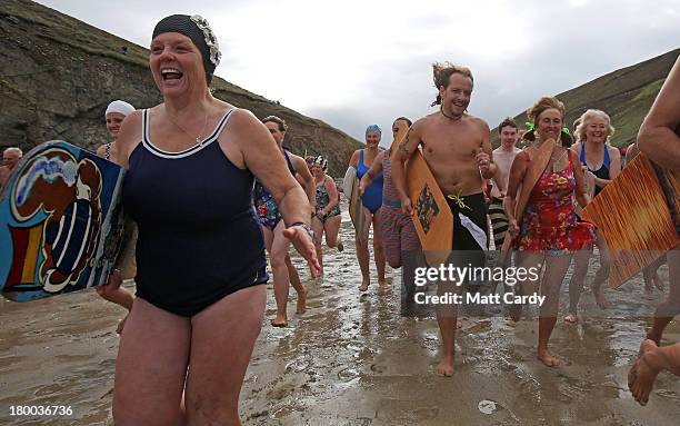 Belly boarders run into the sea to take part in the first heat of the annual World Belly Boarding Championships at Chapel Porth on September 8 2013...