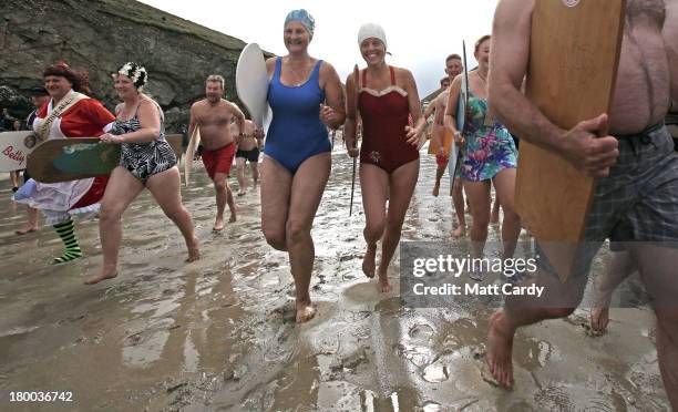 Belly boarders run into the sea to take part in the first heat of the annual World Belly Boarding Championships at Chapel Porth on September 8 2013...