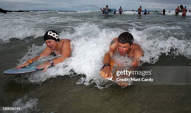 Belly boarders catch a wave as they take part in the first heat of the annual World Belly Boarding Championships at Chapel Porth on September 8 2013...