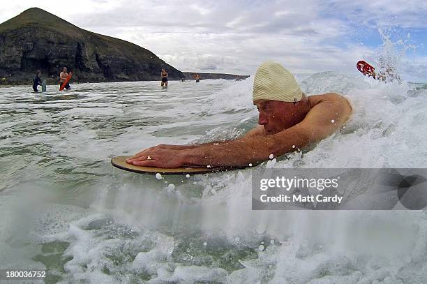 Belly boarder catches a wave as he takes part in a senior mens heat of the annual World Belly Boarding Championships at Chapel Porth on September 8...