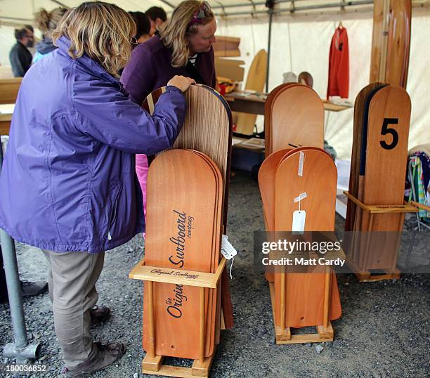 People stop to look at traditional bellyboards displayed for sale at the annual World Belly Boarding Championships at Chapel Porth on September 8...