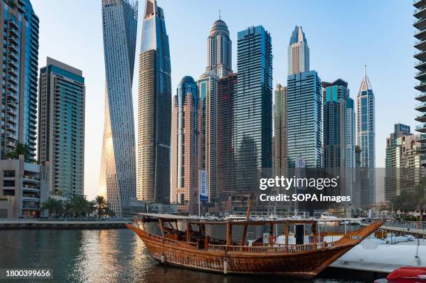 The boat is seen moored with the view of a luxury lifestyle skyscraper apartment complex at the back of Dubai Marina.