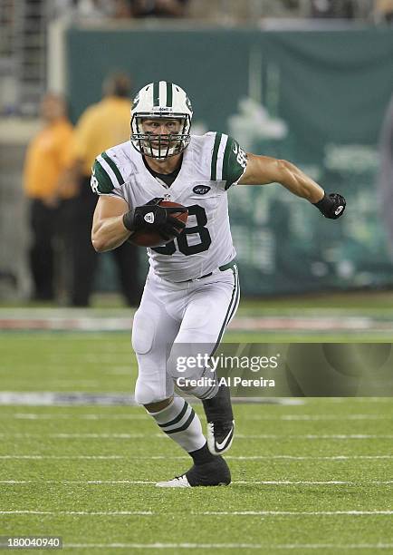 Tight End Konrad Reuland of the New York Jets has a long gain against the Philadelphia Eagles at MetLife Stadium on August 29, 2013 in East...