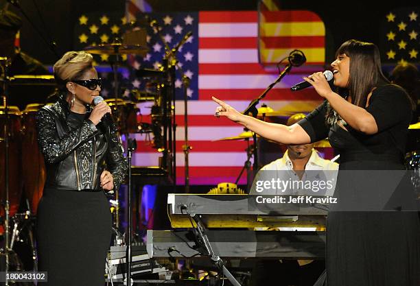 Singers Mary J Blige and Jazmine Sullivan perform at the BET-SOS Saving Ourselves - Help for Haiti Benefit Concert at AmericanAirlines Arena on...