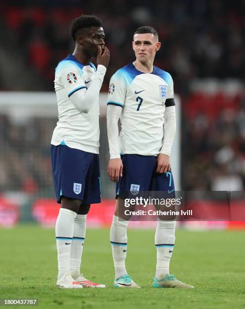 Bukayo Saka of England talks to team mate Phil Foden during the UEFA EURO 2024 European qualifier match between England and Malta at Wembley Stadium...