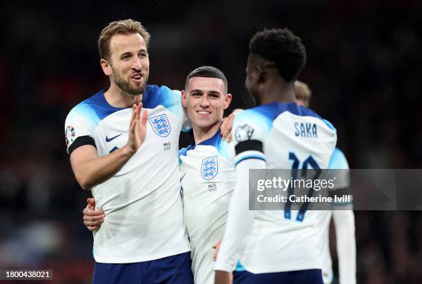 Harry Kane of England celebrates with teammates Bukayo Saka and Phil Foden after scoring the team's second goal during the UEFA EURO 2024 European...