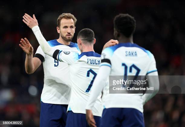 Harry Kane of England celebrates with teammates Bukayo Saka and Phil Foden after scoring the team's second goal during the UEFA EURO 2024 European...