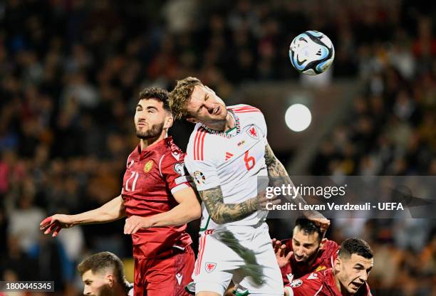 Nair Tiknizyan of Armenia jumps for the ball with Joe Rodon of Wales during the UEFA EURO 2024 European qualifier match between Armenia and Wales at...