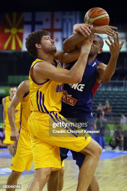 Viacheslav Kravtsov of Ukriane and Nicolas Batum of France fight for the ball during the FIBA European Championships 2013 first round group A match...