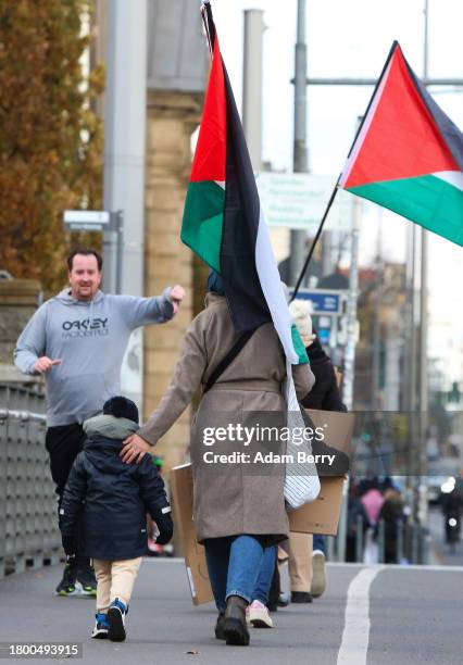 Jogger reacts while passing protesters arriving for a demonstration in support of Palestine amidst the ongoing war in Gaza, which the Israeli...