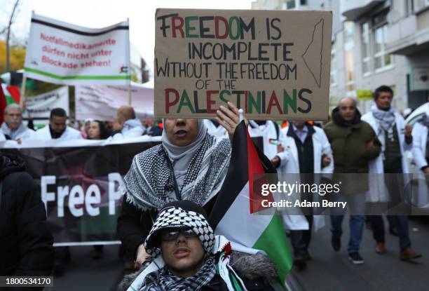 Protester holds a sign reading "Freedom Is Incomplete Without the Freedom of the Palestinians" as she attends a demonstration in support of Palestine...