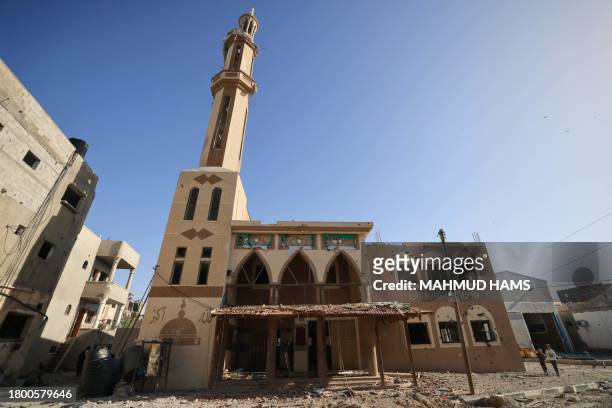 Graphic content / Two Palestinian children stand next to a mosque damaged by Israeli bombardment in the Khezaa district on the eastern outskirts of...