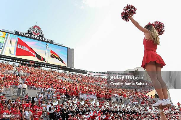 An Ohio State Buckeyes cheerleader cheers for the crowd during a game against the San Diego State Aztecs at Ohio Stadium on September 7, 2013 in...