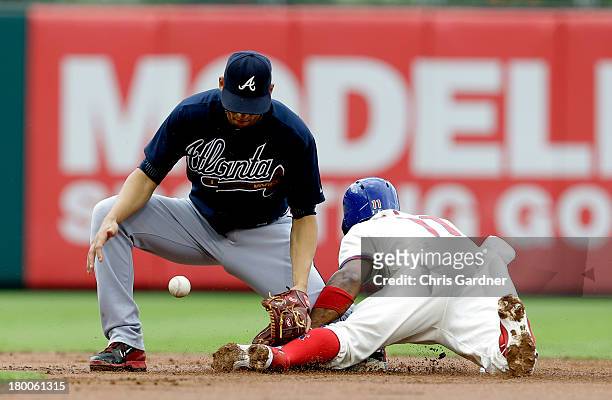 Jimmy Rollins of the Philadelphia Phillies steals second base as Andrelton Simmons of the Atlanta Braves looses control of the throw during the first...