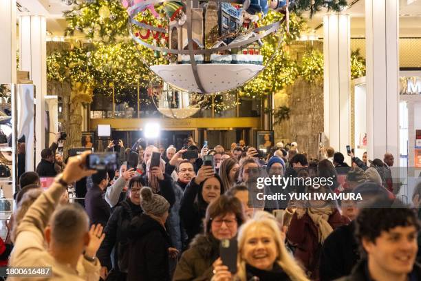 Customers enter Macy's in New York City on "Black Friday," November 24, 2023. The retail sector's efforts to entice holiday gift purchases builds to...