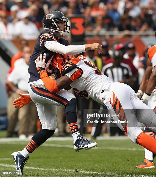 Carlos Dunlap of the Cincinnati Bengals hits Jay Cutler of the Chicago Bears after a pass at Soldier Field on September 8, 2013 in Chicago, Illinois.
